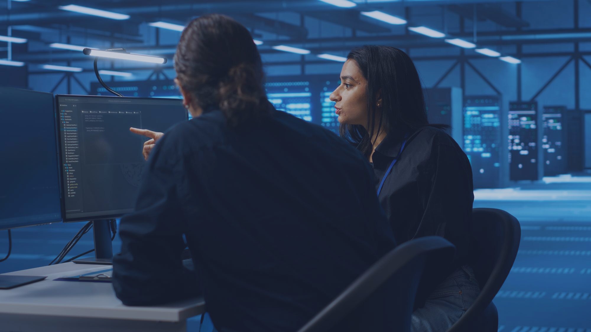 Developers building custom AI software in a dark workspace
